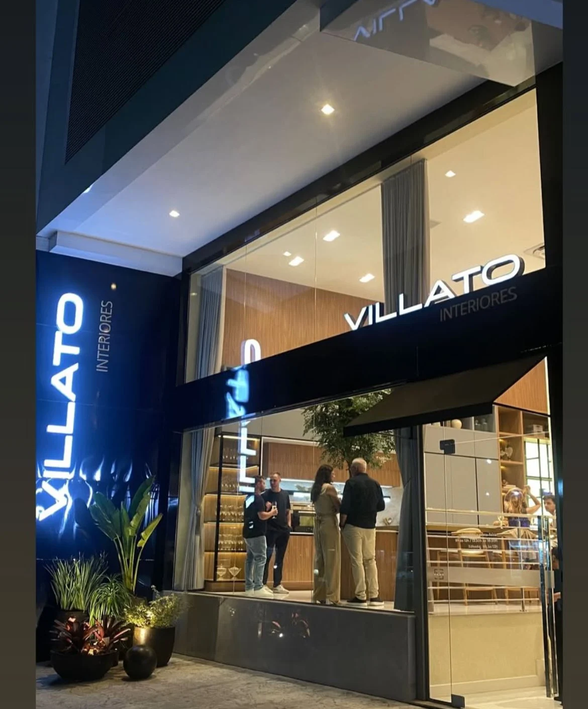 Fachada iluminada da Villato Interiores à noite